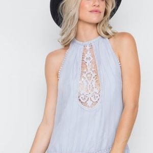 mock neck, lace neck line, crochet trim at the bot